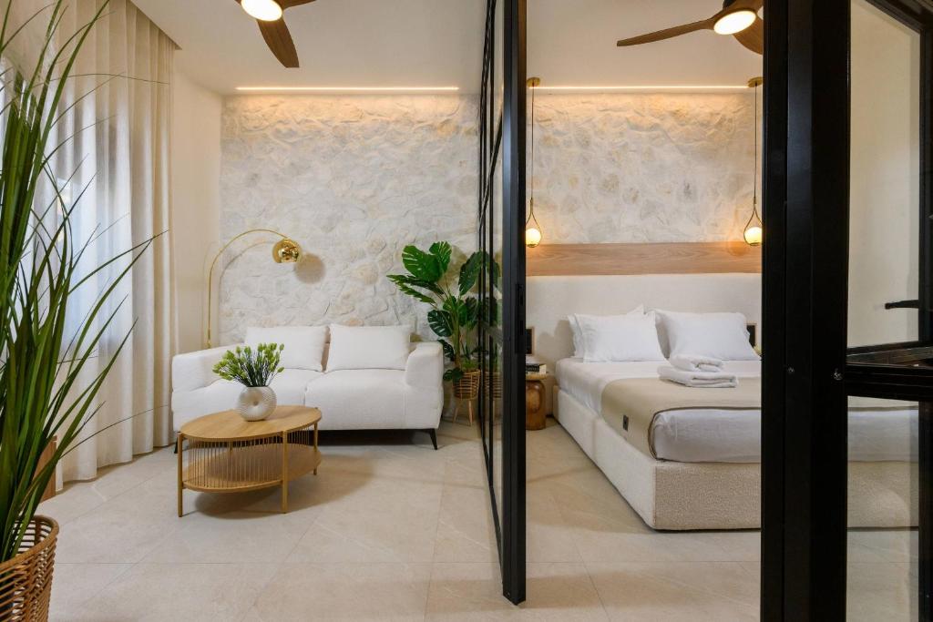 Living area with sofa and flat-screen TV – Sentio Thassos Suites