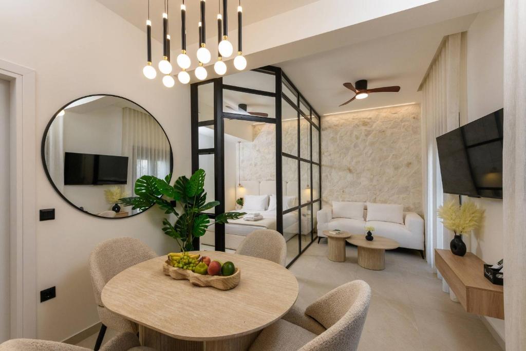 Living area with sofa and flat-screen TV – Sentio Thassos Suites