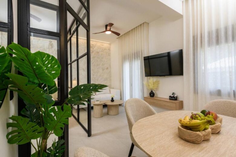 Living area with sofa and flat-screen TV – Sentio Thassos Suites